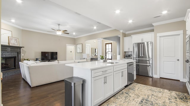 kitchen featuring light countertops, ceiling fan, dark wood finished floors, appliances with stainless steel finishes, and a sink