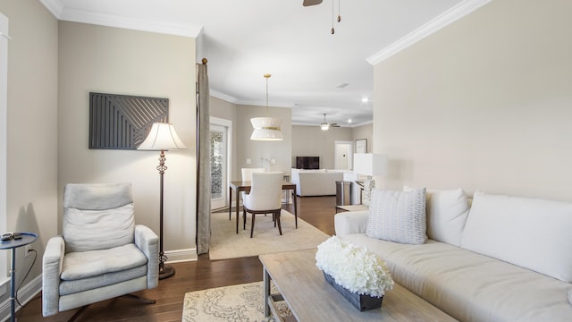 living room with baseboards, ceiling fan, ornamental molding, and dark wood-style flooring