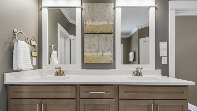 full bath featuring double vanity, a sink, and ornamental molding