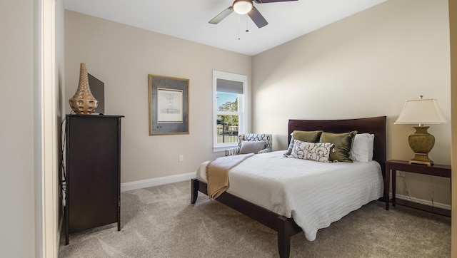 bedroom with light carpet, baseboards, and a ceiling fan