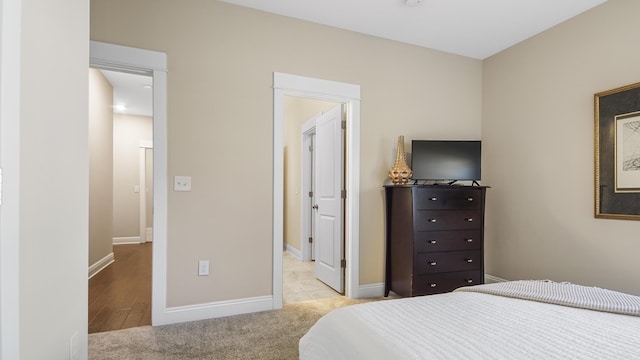 bedroom featuring baseboards and carpet floors
