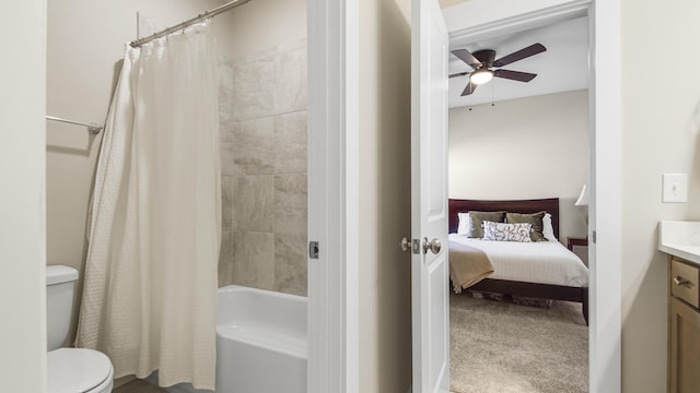 ensuite bathroom featuring vanity, shower / tub combo, toilet, a ceiling fan, and ensuite bathroom