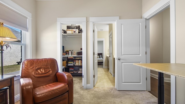 sitting room with light carpet and baseboards