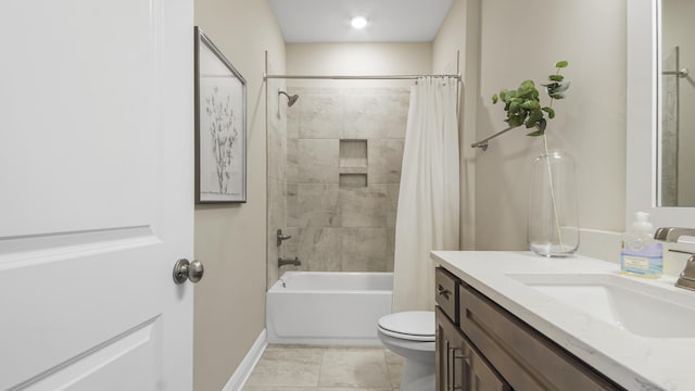 bathroom featuring baseboards, toilet, vanity, and shower / bath combo with shower curtain