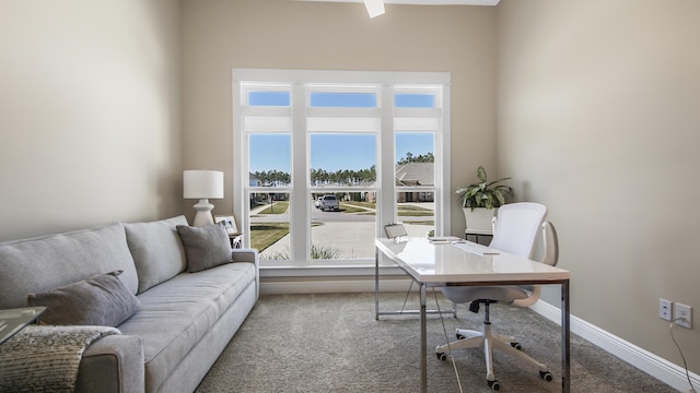 carpeted office featuring baseboards