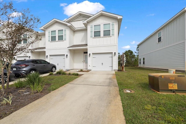 view of front of property with board and batten siding, a front yard, driveway, and an attached garage