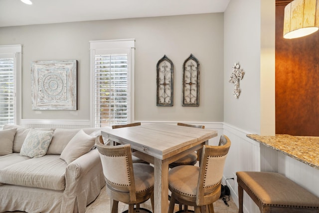 26 Classic Court Ln, Santa Rosa Beach, FL 32459 - dining space featuring light tile patterned floors and wainscoting