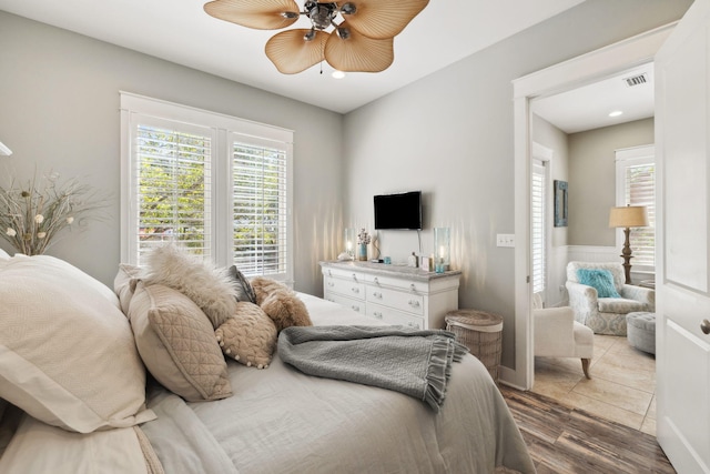 26 Classic Court Ln, Santa Rosa Beach, FL 32459 - bedroom with recessed lighting, a ceiling fan, a wainscoted wall, visible vents, and wood finished floors