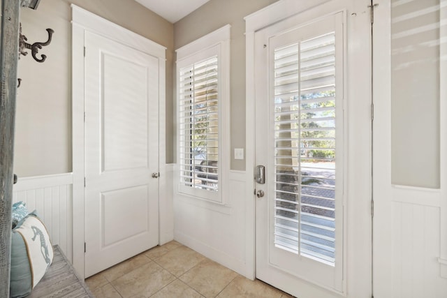 26 Classic Court Ln, Santa Rosa Beach, FL 32459 - entryway with a decorative wall, wainscoting, and light tile patterned flooring