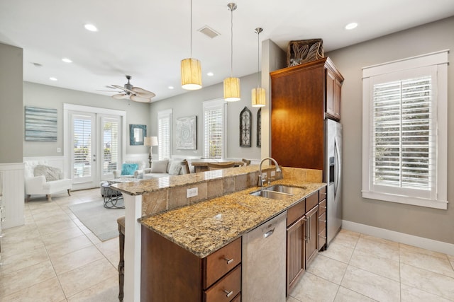 26 Classic Court Ln, Santa Rosa Beach, FL 32459 - kitchen featuring a sink, open floor plan, a kitchen breakfast bar, a peninsula, and stainless steel appliances
