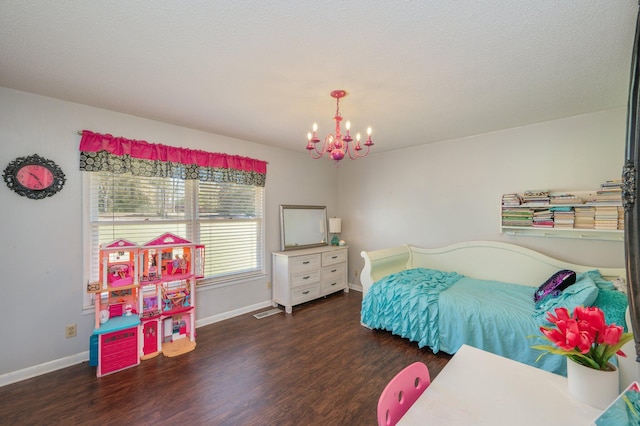 24776 Fifth Ave, Florala, AL 36442 - bedroom featuring visible vents, a notable chandelier, wood finished floors, and baseboards
