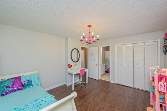 24776 Fifth Ave, Florala, AL 36442 - bedroom featuring baseboards, a textured ceiling, an inviting chandelier, and wood finished floors