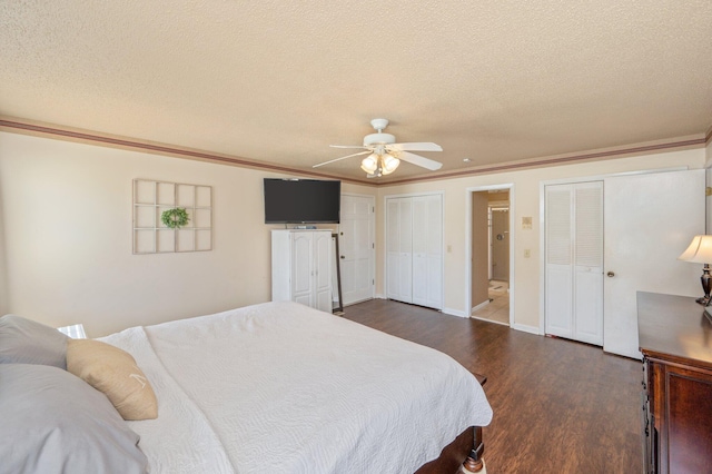24776 Fifth Ave, Florala, AL 36442 - bedroom with a textured ceiling, dark wood-type flooring, multiple closets, and ornamental molding