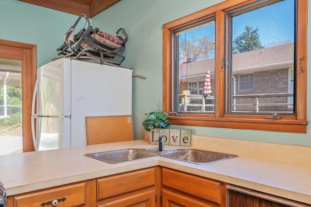 24776 Fifth Ave, Florala, AL 36442 - kitchen with light countertops, freestanding refrigerator, and a sink