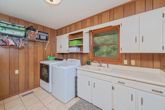 24776 Fifth Ave, Florala, AL 36442 - laundry room with visible vents, a sink, cabinet space, light tile patterned floors, and washing machine and clothes dryer