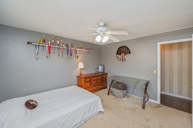 24776 Fifth Ave, Florala, AL 36442 - carpeted bedroom featuring baseboards, a textured ceiling, and a ceiling fan