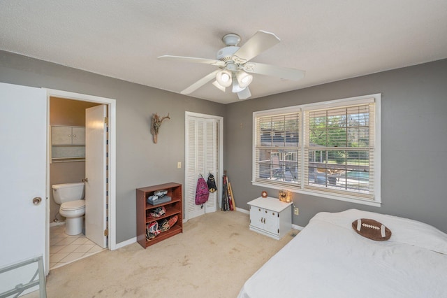 24776 Fifth Ave, Florala, AL 36442 - bedroom featuring a closet, connected bathroom, baseboards, and carpet floors
