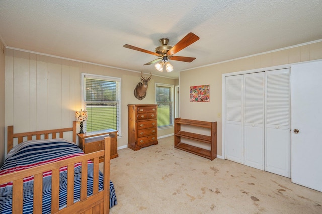 24776 Fifth Ave, Florala, AL 36442 - bedroom featuring a textured ceiling, a closet, crown molding, light colored carpet, and ceiling fan