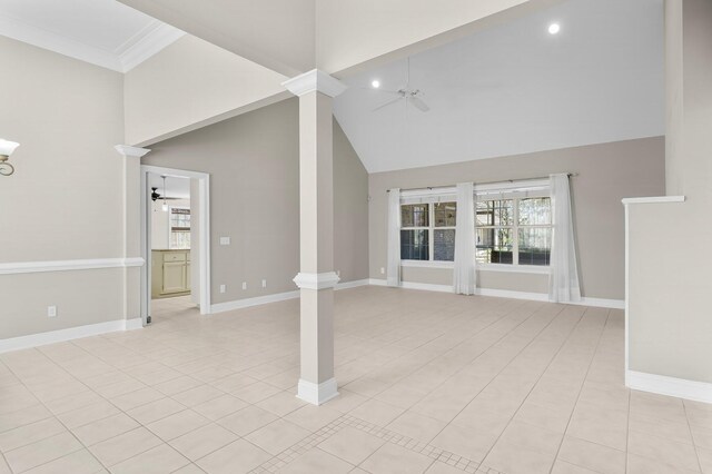 2511 Parkwood Dr, Panama City, FL 32405 - unfurnished living room with baseboards, high vaulted ceiling, ceiling fan, and decorative columns