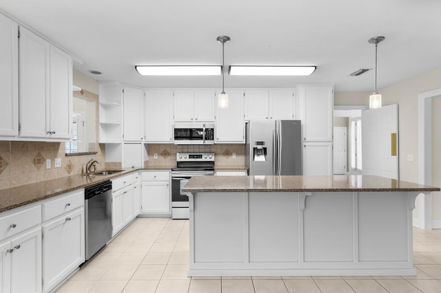 2511 Parkwood Dr, Panama City, FL 32405 - kitchen with open shelves, a sink, stainless steel appliances, white cabinetry, and a center island