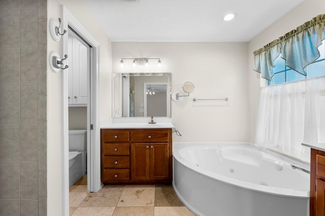 2511 Parkwood Dr, Panama City, FL 32405 - bathroom featuring vanity, a jetted tub, toilet, and ceiling fan