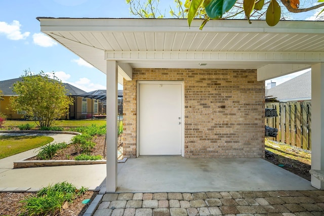 2511 Parkwood Dr, Panama City, FL 32405 - property entrance with fence, brick siding, and a patio area