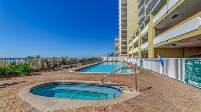 10519 Front Beach Rd Unit 1904B, Panama City Beach, FL 32407 - community pool featuring a patio, a community hot tub, and fence