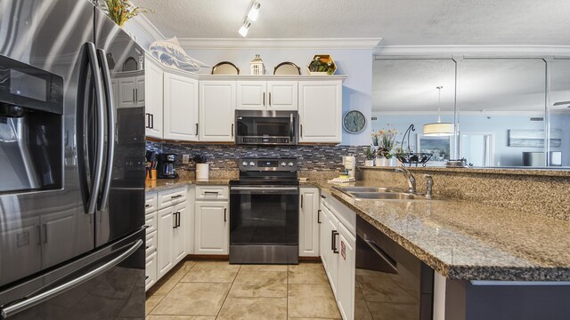 10519 Front Beach Rd Unit 1904B, Panama City Beach, FL 32407 - kitchen featuring backsplash, ornamental molding, a peninsula, a textured ceiling, and stainless steel appliances