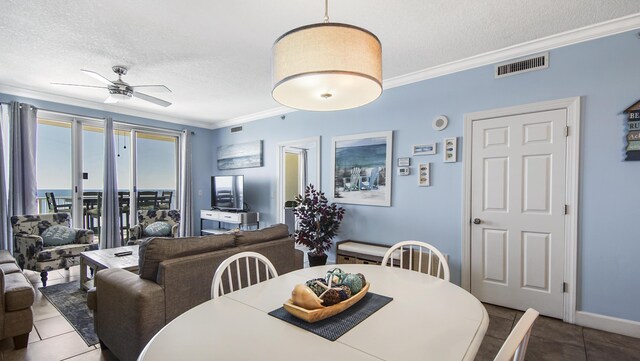 10519 Front Beach Rd Unit 1904B, Panama City Beach, FL 32407 - tiled dining area with baseboards, visible vents, ceiling fan, a textured ceiling, and crown molding