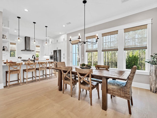 290 White Cottage Rd, Santa Rosa Beach, FL 32459 - dining area featuring recessed lighting, a chandelier, light wood-type flooring, crown molding, and baseboards