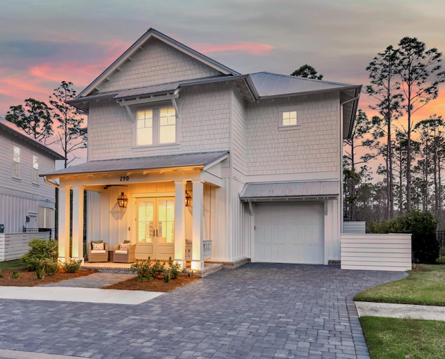 290 White Cottage Rd, Santa Rosa Beach, FL 32459 - view of front facade featuring a garage, metal roof, decorative driveway, board and batten siding, and french doors