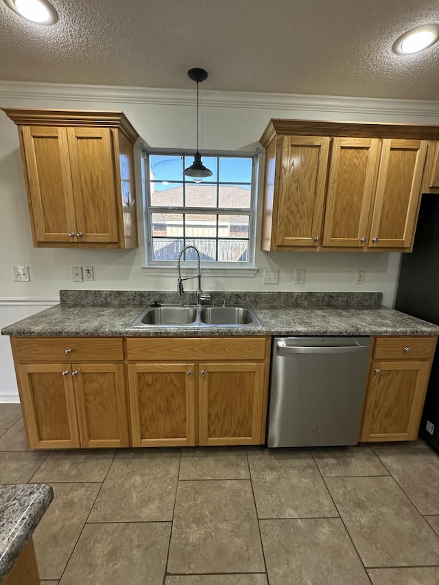 kitchen featuring a sink, dark countertops, crown molding, and stainless steel dishwasher