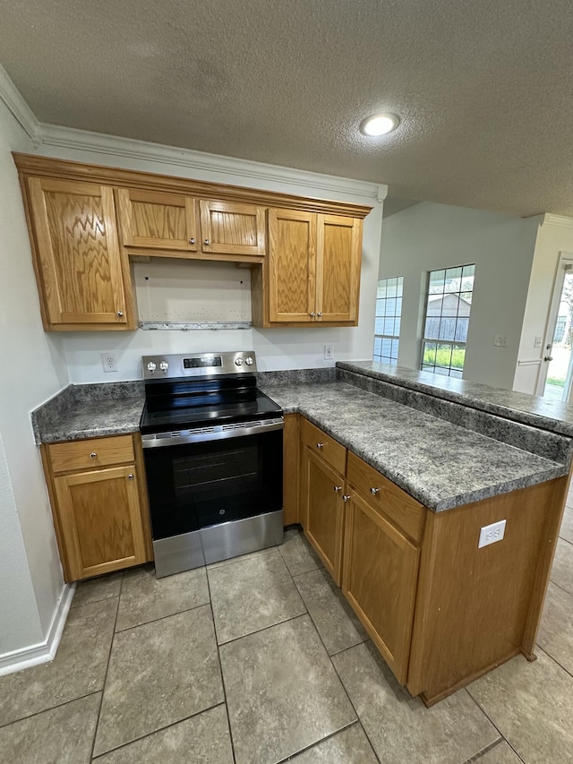 kitchen with a textured ceiling, a peninsula, brown cabinets, lofted ceiling, and stainless steel electric stove