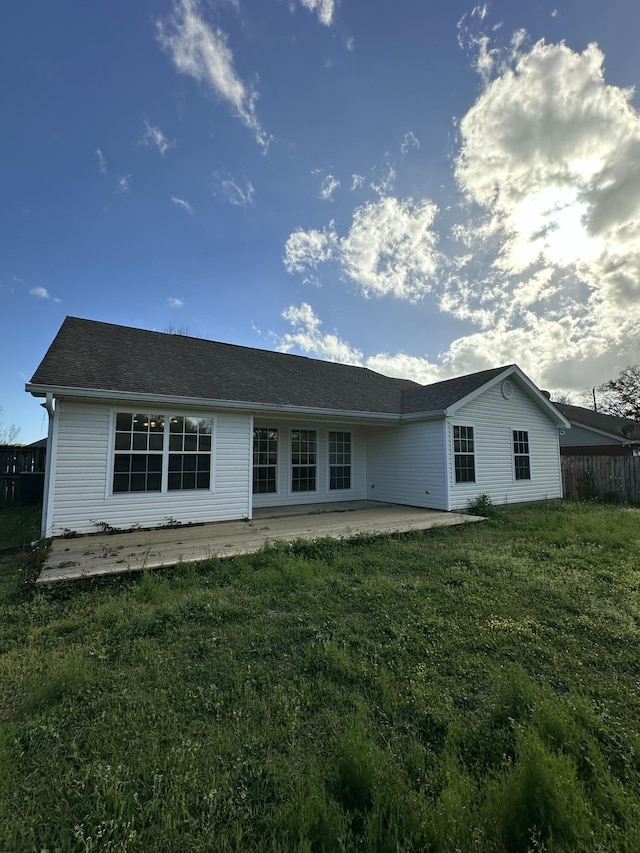 back of house with fence, a yard, and a patio