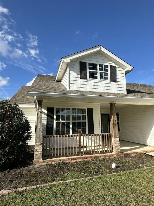 view of front of home featuring a porch and roof with shingles