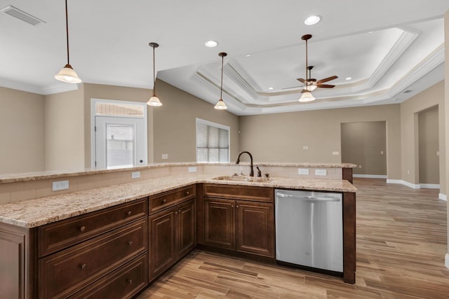 kitchen featuring a raised ceiling, a sink, visible vents, dishwasher, and a ceiling fan
