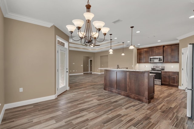 kitchen with crown molding, baseboards, visible vents, appliances with stainless steel finishes, and wood finished floors