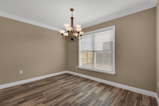 empty room featuring baseboards, dark wood-style flooring, ornamental molding, and an inviting chandelier