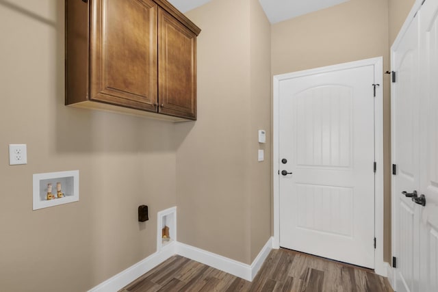 washroom with hookup for a washing machine, baseboards, hookup for an electric dryer, cabinet space, and dark wood-style floors
