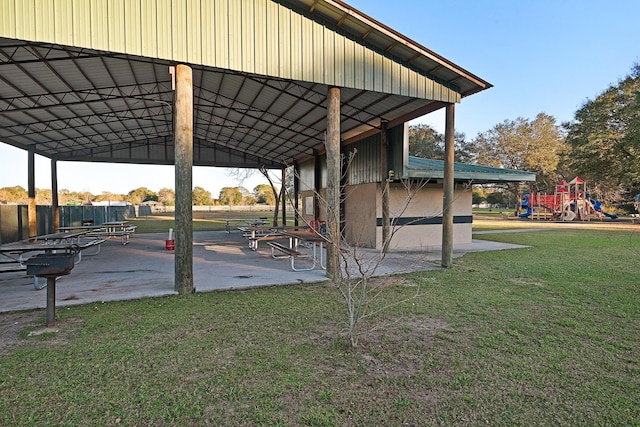 exterior space with playground community and a lawn