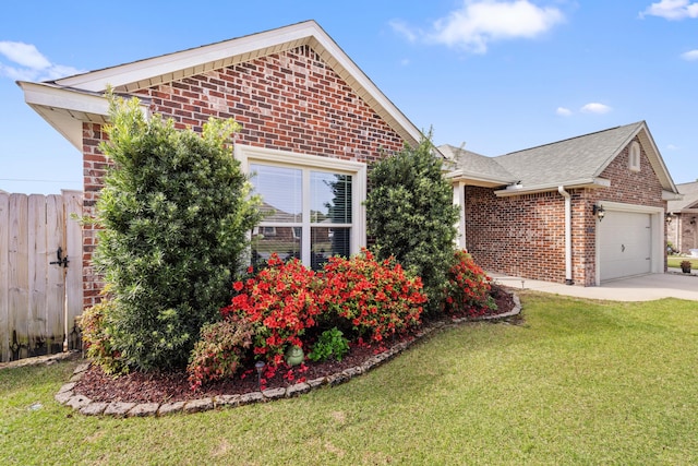 view of front of home featuring concrete driveway, fence, an attached garage, a front yard, and brick siding