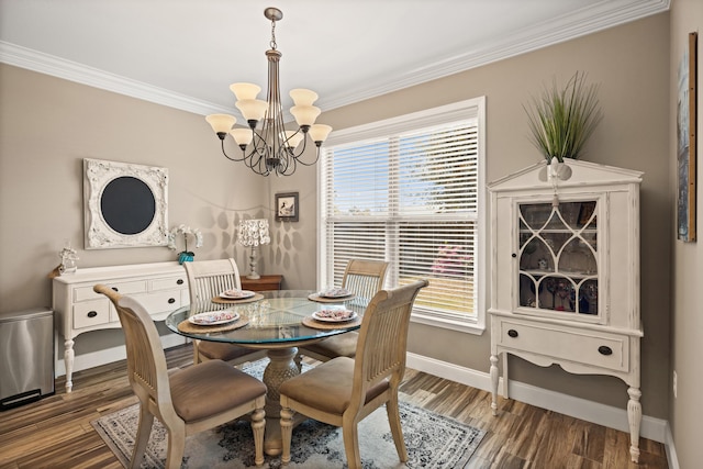 dining area featuring a healthy amount of sunlight, wood finished floors, and a chandelier