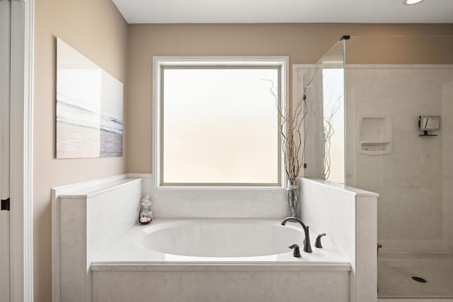 bathroom featuring a bath and walk in shower
