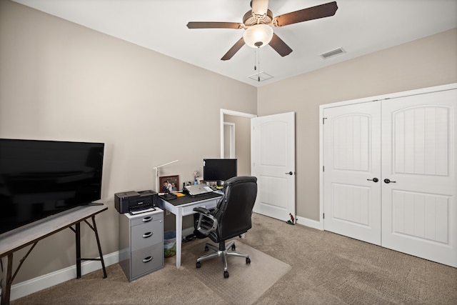 office space with baseboards, visible vents, carpet, and a ceiling fan