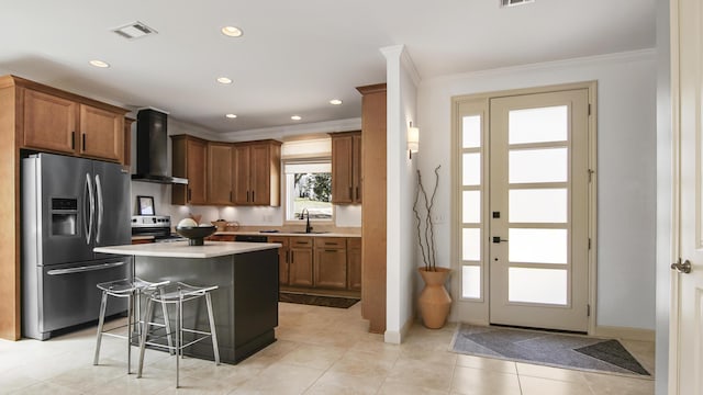 13 Taylor Krenkel Ct, Santa Rosa Beach, FL 32459 - kitchen with light countertops, wall chimney exhaust hood, a kitchen bar, stainless steel appliances, and visible vents