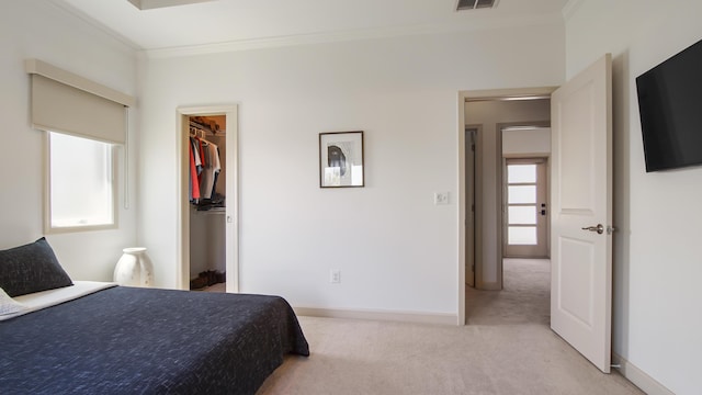 13 Taylor Krenkel Ct, Santa Rosa Beach, FL 32459 - bedroom with a walk in closet, baseboards, light colored carpet, visible vents, and ornamental molding