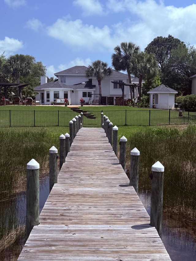 dock area with a lawn and fence private yard