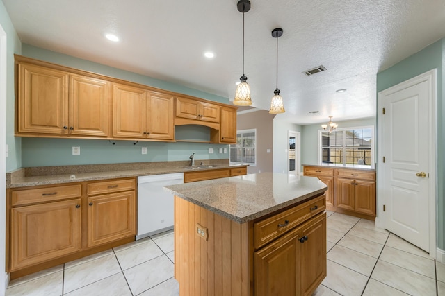 kitchen featuring a center island, a sink, dishwasher, and light tile patterned floors