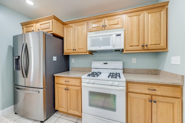 kitchen with white appliances, light tile patterned floors, and light brown cabinets