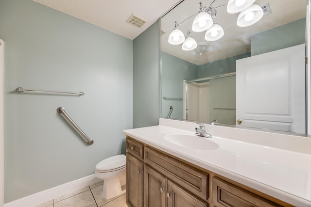 bathroom featuring toilet, vanity, tile patterned flooring, a shower with shower door, and visible vents